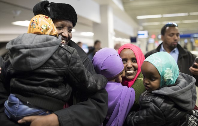 Mohamed lye held his 4-year-old daughter Nimo, as he was reunited with his wife Saido Ahmed Abdille (wearing red scarf) and their other daughter Nafiso, 2, at right at MSP Airport after arriving from Amsterdam Sunday Feb 5, 2017 in Bloomington, MN. JERRY HOLT ï jerry.holt@startribune.com